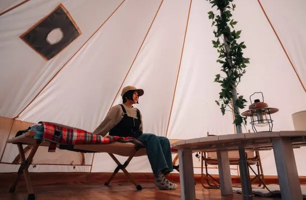 ベルテントの中でリラックスする女性