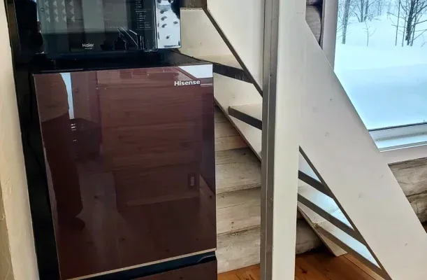 Refrigerator and microwave inside a log house